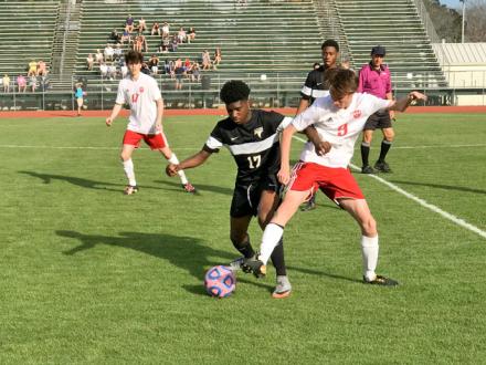 Soccer players fight for ball