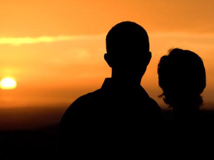 Couple watches Sunset on Alabama's Beaches