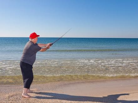 man surf fishing in Gulf Shores Al