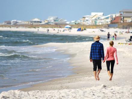 Couple walks along Alabamas Beaches