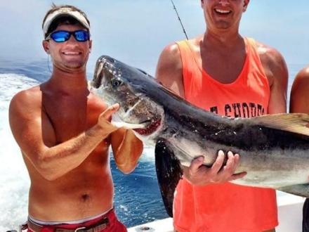 men holding fish in orange beach al