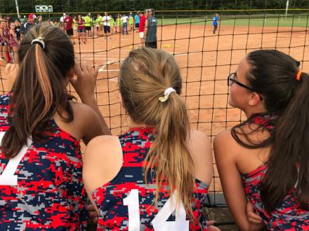 Softball girls watch game