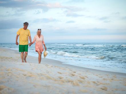 Couple walks on Alabama's Beaches