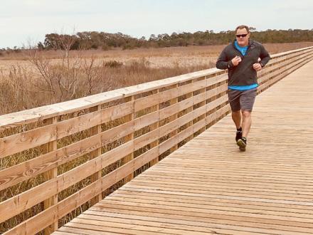 Man runs on boardwalk in Orange Beach
