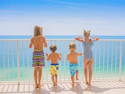 Children stand on condo Balcony on Alabama's Beaches
