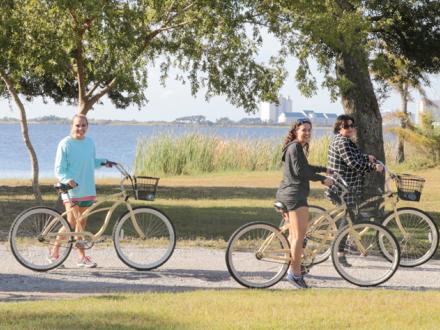 Women bike riding on Alabama Gulf Coast