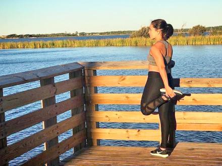 Runner stretching on Hugh S. Branyon BackCountry Trail in Orange Beach