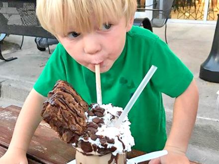 Boy enjoys milkshake at The Yard Milkshake Bar in Gulf Shores