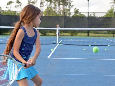 Young Girl plays tennis