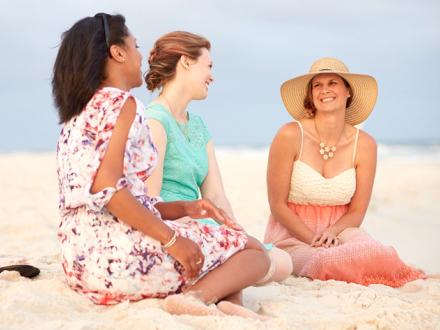 Girl friends sitting on Alabama's white sand beaches