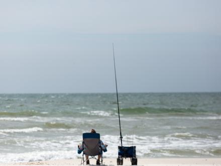 Man fishing on the beach in Orange Beach AL