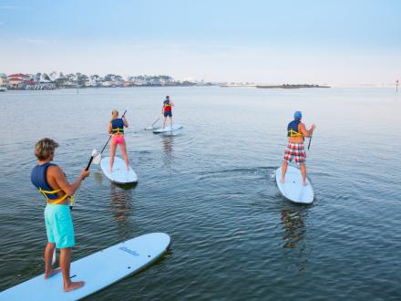 Family paddleboarding in Orange Beach, AL