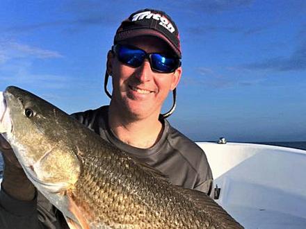 Man with redfish in Orange Beach, AL