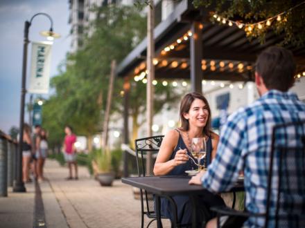 Couple dining at Ginny Lane Bar & Grill at The Wharf in Orange Beach, AL
