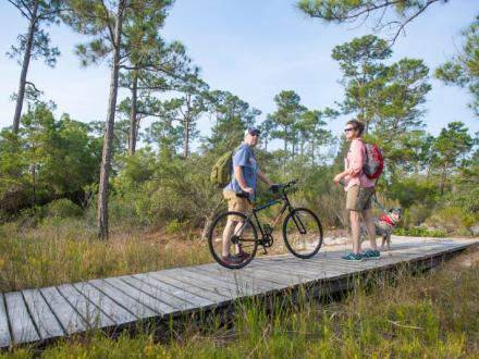 Couple biking at the Gulf State Park in Gulf Shores, AL