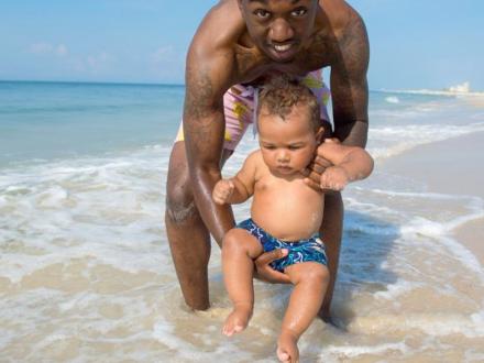 Baby splashing in Gulf waves
