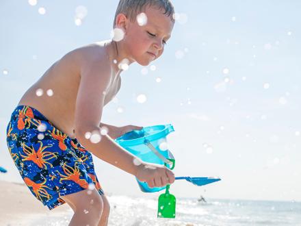 boy playing on Alabama's Beaches