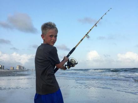 Young boy surf fishing on Alabama's beaches
