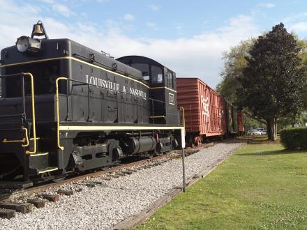 A steam engine locomotive stands outside Foley’s Model Train and Railroad Museum in Foley, Alabama, where visitors can learn about the history of trains in Alabama.