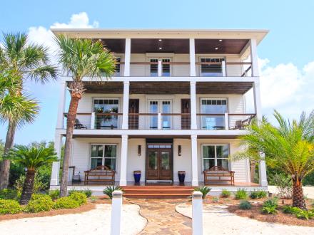 Beach house rental with Gulf view in Alabama’s Beaches, featuring spacious balconies and lush landscaping