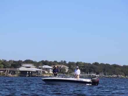 Boat cruising through the Intercoastal Waterway in Orange Beach