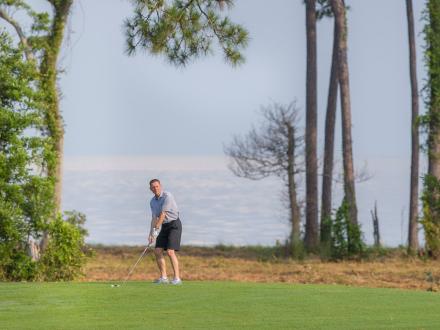 Man playing golf at Peninsula Golf and Racquet Club in Fort Morgan.
