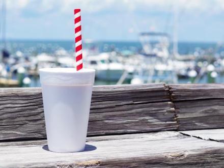Classic bushwacker served in a chilled cup with a striped straw at Tacky Jacks, overlooking the scenic marina