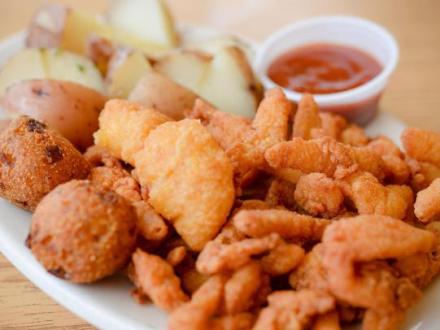 a plate of fried shrimp and potatoes at Mikee's seafood
