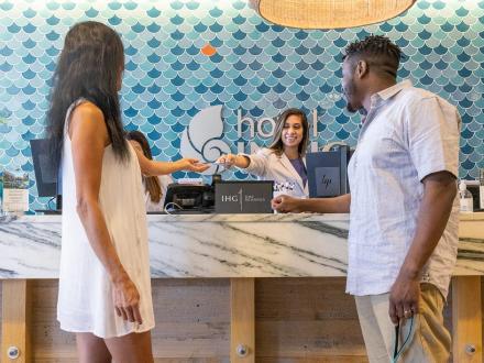 Couple checking into Hotel Indigo in Orange Beach