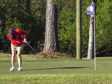 Woman golfing at One Club Golf Course