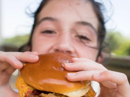 Girl eating at Burger at LuLu's