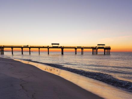 Pier on the beach at sunrise in Orange Beach