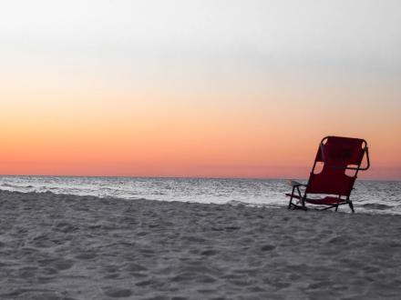 Beach chair on the shore at sunrise in Gulf Shores