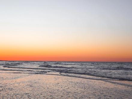 Vivid orange and red sunrise over the beach in Gulf Shores, best sunrise spot