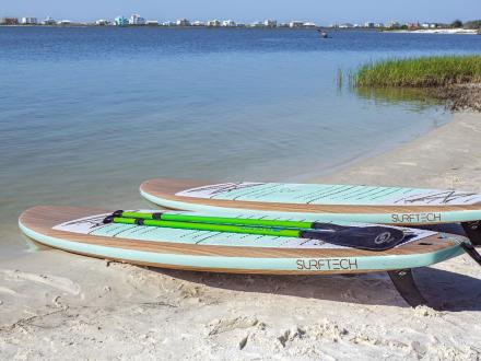 Two paddle boards laying flat on the tide line in Alabama's Beaches