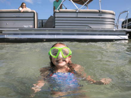 A family enjoying an exciting coastal adventure on a boat in Orange Beach, AL
