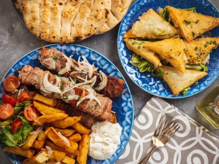 Table filled with plates of Greek food