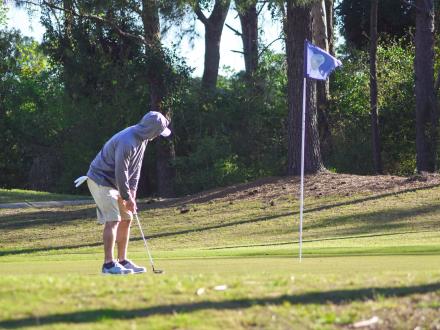 Man putting at One Club Golf Course in Gulf Shores