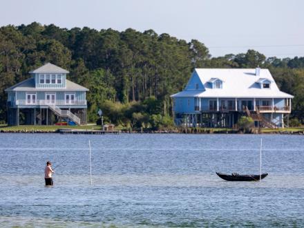 Man fishing in the water at Little Lagoon in Gulf Shores