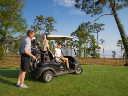 Two players at their golf cart at Peninsula Golf Club in Gulf Shores