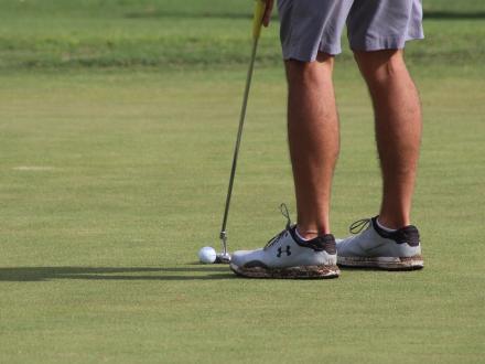Player putting a golf ball at Craft Farms golf course