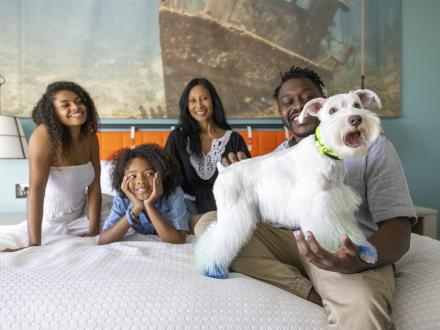 A family with their pet enjoying their Alabama's Beaches vacation rental