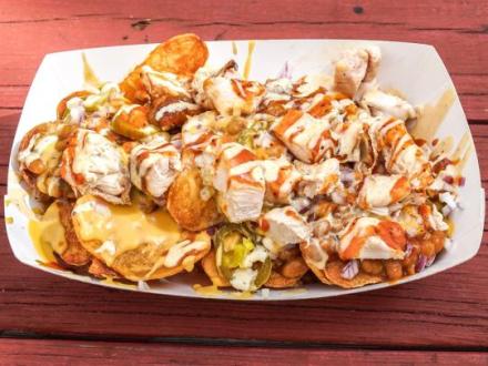 a plate of BBQ chicken nachos at Moe's Bar B Que in Orange Beach