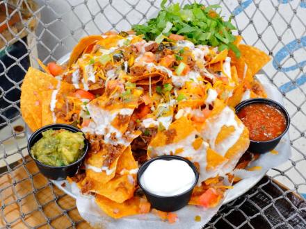 a plate of loaded nachos at The Sloop restaurant in Gulf Shores