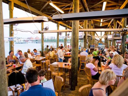 People dining by the water at Tacky Jacks restaurant