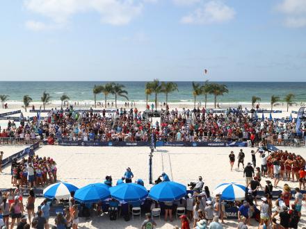 View of the court and crowd at the NCAA Beach Volleyball Championship trophy in the sand at Gulf Shores