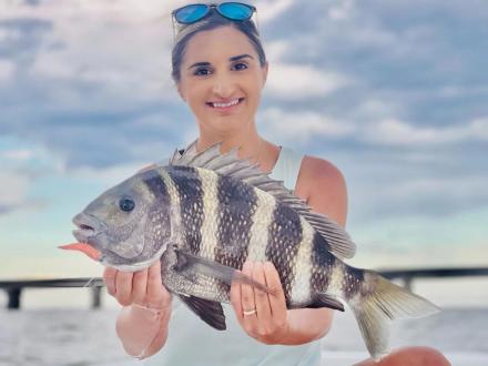 Woman holding a sheepshead caught inshore fishing in Orange Beach