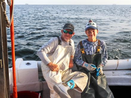 Two anglers on a shark fishing charter by Apex in Orange Beach