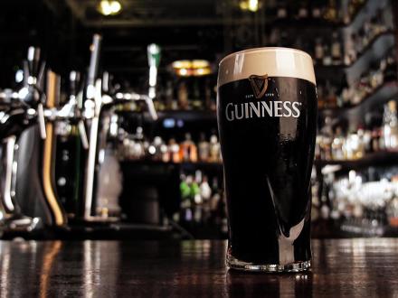 A pint of Guinness sitting on a bar
