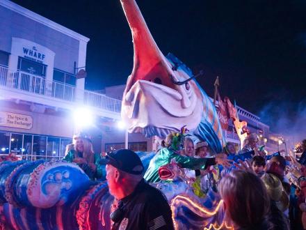 Nighttime Mardi Gras parade at The Wharf